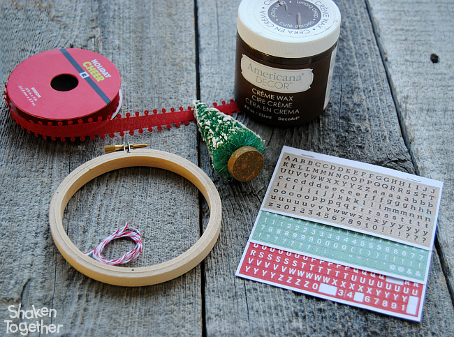 Trim your tree with these easy Embroidery Hoop Christmas Ornaments! Add a bottle brush tree and a red ribbon to a faux stained embroidery hoop for a charming DIY ornament!