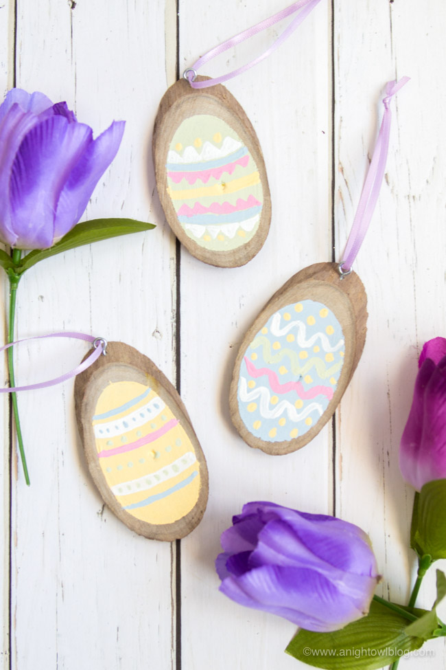 Perfect for Easter Decor, Easter Basket tags and more, create these adorable and easy Painted Wood Slice Easter Eggs in just minutes!
